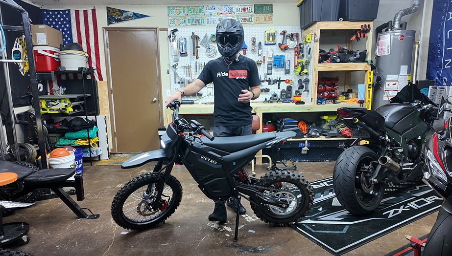 Electric dirt bike stored in a garage for winter maintenance